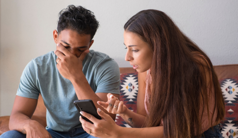 couple sitting on sofa upset Insecurities After Being Cheated On