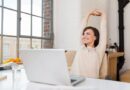 Woman smiling and relaxing while sitting in her office.