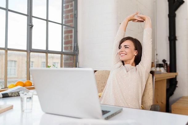 Woman smiling and relaxing while sitting in her office.