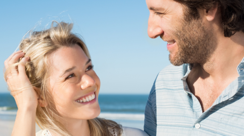 couple smiling at each other at beach Cute Things to Say to Your Crush