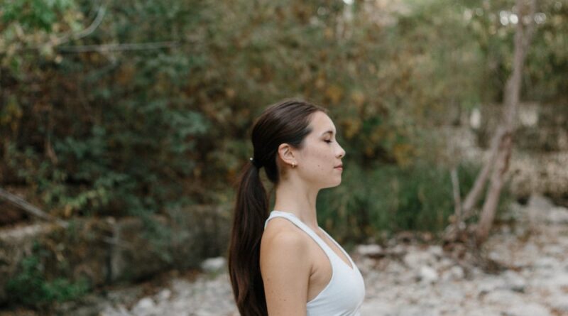 woman sitting on a rock in a seated position_birth control and vitamin deficiency