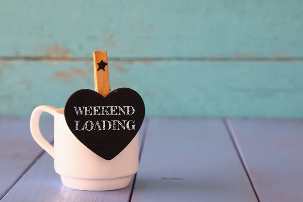 A coffee cup with a note that says: Weekend Loading.