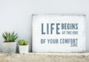 A poster about how life begins at the end of the comfort zone and two cactuses.