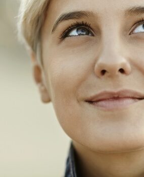 A smiling woman looking up.