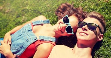 Smiling couple lying in the spring grass.