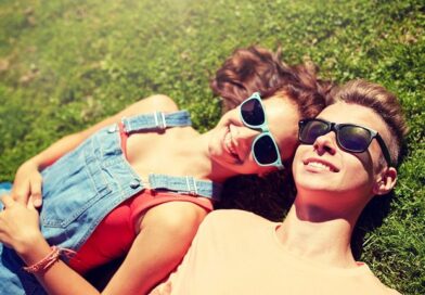 Smiling couple lying in the spring grass.