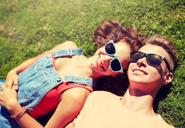 Smiling couple lying in the spring grass.