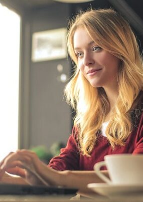A focused woman working on her laptop.