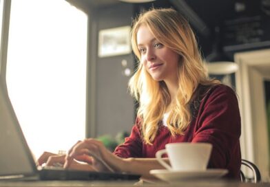 A focused woman working on her laptop.