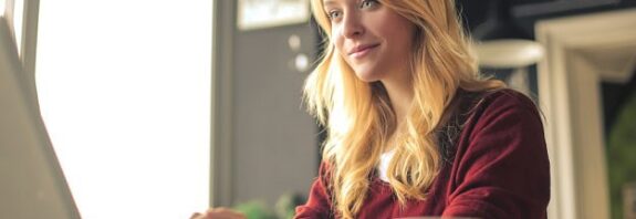 A focused woman working on her laptop.