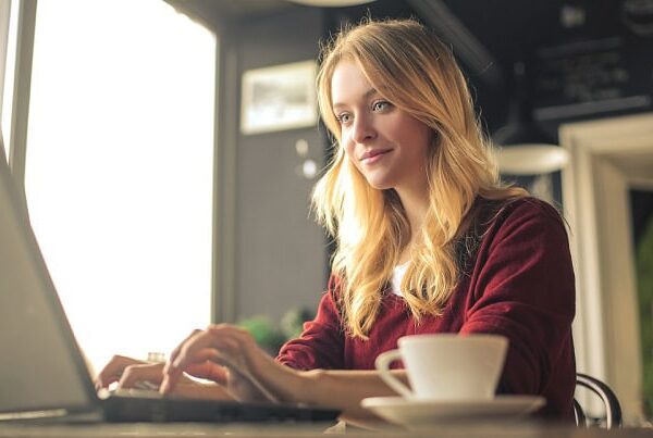 A focused woman working on her laptop.