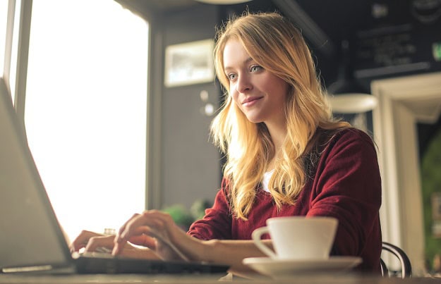 A focused woman working on her laptop.