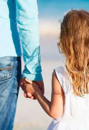 A young girl holding her father