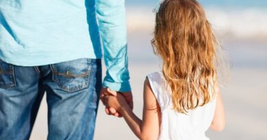 A young girl holding her father