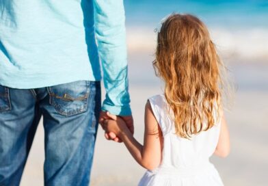 A young girl holding her father