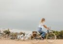 Woman riding bike outside.