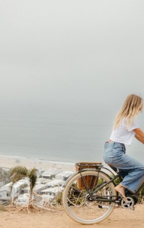Woman riding bike outside.