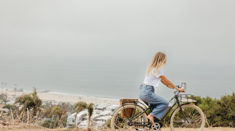 Woman riding bike outside.